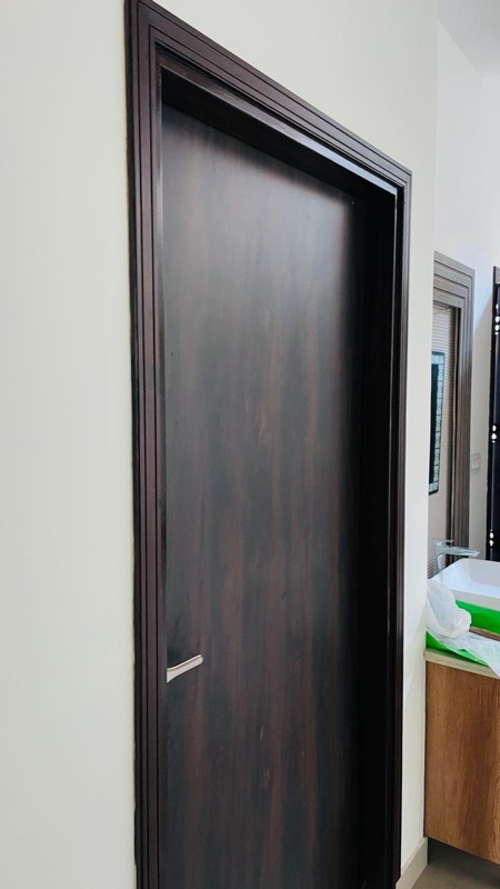 Wood-finish steel door frame installed by Shyam Steel Industries